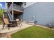 Private backyard featuring a patio with dining area, turf, and a relaxing hot tub area at 9682 Dunning Cir, Highlands Ranch, CO 80126