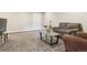 Finished basement with gray carpet, neutral walls, and a cozy sitting area at 9682 Dunning Cir, Highlands Ranch, CO 80126