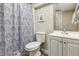 Cozy bathroom featuring patterned shower curtain, framed art, and updated vanity at 9682 Dunning Cir, Highlands Ranch, CO 80126