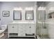 Bathroom featuring a double sink vanity, and a glass-enclosed shower with tiled walls at 9682 Dunning Cir, Highlands Ranch, CO 80126