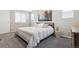 Bright bedroom with large windows, soft carpet, and a cozy bed at 9682 Dunning Cir, Highlands Ranch, CO 80126