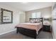 Bright bedroom featuring neutral decor, a comfortable queen-size bed, and carpeted flooring at 9682 Dunning Cir, Highlands Ranch, CO 80126