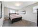 Cozy bedroom featuring neutral decor, a comfortable queen-size bed, and carpeted flooring at 9682 Dunning Cir, Highlands Ranch, CO 80126