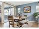 This shows the dining area with a wooden table, a bench, and natural light streaming in, great for cozy meals at 9682 Dunning Cir, Highlands Ranch, CO 80126