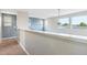 Hallway featuring multiple windows, neutral walls, and carpeted flooring at 9682 Dunning Cir, Highlands Ranch, CO 80126