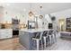Modern kitchen with a large island, stainless steel appliances, and pendant lighting, ideal for cooking and entertaining at 9682 Dunning Cir, Highlands Ranch, CO 80126