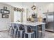 Modern kitchen featuring a large island, stainless steel appliances, pendant lighting, and light wood flooring at 9682 Dunning Cir, Highlands Ranch, CO 80126