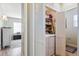 Laundry area with a washer, dryer, and shelving for storage, and extra storage chest at 9682 Dunning Cir, Highlands Ranch, CO 80126
