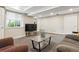 Spacious living area with gray carpet, a couch, window and a TV setup at 9682 Dunning Cir, Highlands Ranch, CO 80126