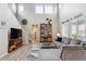 Bright living room with soaring ceilings, a decorative staircase, and a cozy seating area perfect for relaxation at 9682 Dunning Cir, Highlands Ranch, CO 80126