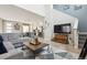 The living room leads to the kitchen and dining, featuring a modern aesthetic and a comfortable atmosphere at 9682 Dunning Cir, Highlands Ranch, CO 80126