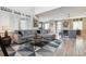 Spacious living room open to dining and kitchen area featuring modern finishes and a comfortable, stylish design at 9682 Dunning Cir, Highlands Ranch, CO 80126