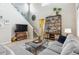 This wide shot showcases an airy living room with its high ceilings, stylish decor, and comfortable seating arrangement at 9682 Dunning Cir, Highlands Ranch, CO 80126