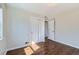 Simple bedroom features hardwood floors, natural light, closet space, and inviting atmosphere at 1261 S Harrison St, Denver, CO 80210