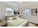 Relaxing bedroom features neutral tones, lots of natural light, and hardwood floors at 1261 S Harrison St, Denver, CO 80210