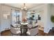 Modern dining room featuring a glass table set for four and an open concept to the kitchen at 1261 S Harrison St, Denver, CO 80210