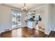 Inviting dining area with hardwood floors, a backyard view, and an open layout to the kitchen at 1261 S Harrison St, Denver, CO 80210