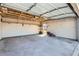 Spacious garage featuring an automatic door, concrete flooring, and ample shelving for organized storage at 1261 S Harrison St, Denver, CO 80210