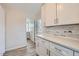 Charming laundry room with modern white cabinets and rustic wood backsplash, adding character at 1261 S Harrison St, Denver, CO 80210