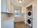 Bright laundry room featuring new washer and dryer with storage, enhancing convenience at 1261 S Harrison St, Denver, CO 80210