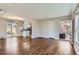 Open-concept living space with hardwood floors, neutral paint, and ample natural light from the windows at 1261 S Harrison St, Denver, CO 80210