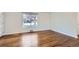 Bright living room with hardwood floors, a large window, and modern neutral paint and accents at 1261 S Harrison St, Denver, CO 80210