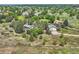 Aerial view of a property with a well-maintained house, large garage, and lush green surroundings in a quiet neighborhood at 6351 S Andes Pl, Centennial, CO 80016