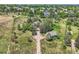Aerial view of a property with a long driveway and separate garage, surrounded by green fields and mature trees at 6351 S Andes Pl, Centennial, CO 80016