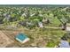 Serene aerial shot of a house with a detached garage on a large grassy property near other neighborhood homes at 6351 S Andes Pl, Centennial, CO 80016