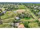 Aerial view showcasing property with a home, outbuildings, and expansive grassy areas in a residential setting at 6351 S Andes Pl, Centennial, CO 80016