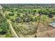 Aerial view of grassy property with multiple structures and surrounding neighborhood at 6351 S Andes Pl, Centennial, CO 80016