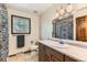 Well-lit bathroom featuring a wood vanity, sink, and patterned shower curtain, offering a clean and functional design at 6351 S Andes Pl, Centennial, CO 80016