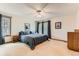 Bright bedroom with balcony access, ceiling fan, and plush carpet offers a peaceful retreat at 6351 S Andes Pl, Centennial, CO 80016