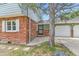 Close-up showcasing the brick facade, white shutters, and the home's entryway at 6351 S Andes Pl, Centennial, CO 80016