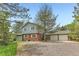 Charming two-story home featuring a brick facade, white shutters, and a spacious three-car garage at 6351 S Andes Pl, Centennial, CO 80016