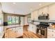 Updated kitchen with granite counters, stainless appliances, and hardwood floors offers modern convenience at 6351 S Andes Pl, Centennial, CO 80016