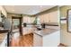 Modern kitchen featuring stainless steel appliances, granite countertops, and hardwood floors at 6351 S Andes Pl, Centennial, CO 80016