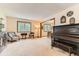 The neutral living room is spacious and has views to the backyard from the bright windows at 6351 S Andes Pl, Centennial, CO 80016