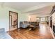 Spacious living room seamlessly connects to other rooms, and features hardwood floors and cozy fireplace at 6351 S Andes Pl, Centennial, CO 80016