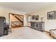 The living room is bright and has views to the staircase, front yard and a dining area at 6351 S Andes Pl, Centennial, CO 80016