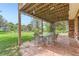 Charming brick patio under a deck with string lights, perfect for outdoor dining and entertaining guests at 6351 S Andes Pl, Centennial, CO 80016