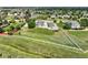 Expansive aerial view of a home with a large yard, detached garage, and surrounding neighborhood at 16110 Poplar St, Brighton, CO 80602