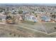Aerial view of a large lot with a home and detached garage in a residential neighborhood at 16110 Poplar St, Brighton, CO 80602