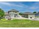 Backyard view of a two-story home, detached garage, and patio area at 16110 Poplar St, Brighton, CO 80602