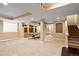 Spacious finished basement with carpet, built-in shelving and a ping pong table at 16110 Poplar St, Brighton, CO 80602