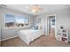 Comfortable bedroom featuring a ceiling fan, large window with a view, and plenty of sunlight at 16110 Poplar St, Brighton, CO 80602