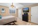 Comfortable bedroom featuring a tray ceiling, a TV, and ample closet space at 16110 Poplar St, Brighton, CO 80602