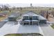 Charming two-story home featuring a spacious driveway, stone accents, manicured lawn and a detached garage at 16110 Poplar St, Brighton, CO 80602