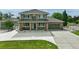 Charming two-story home with a brick-accented facade, well-manicured lawn, and a spacious driveway at 16110 Poplar St, Brighton, CO 80602