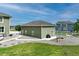 Detached garage with matching trim, with an outdoor entertaining area including a grill and seating at 16110 Poplar St, Brighton, CO 80602